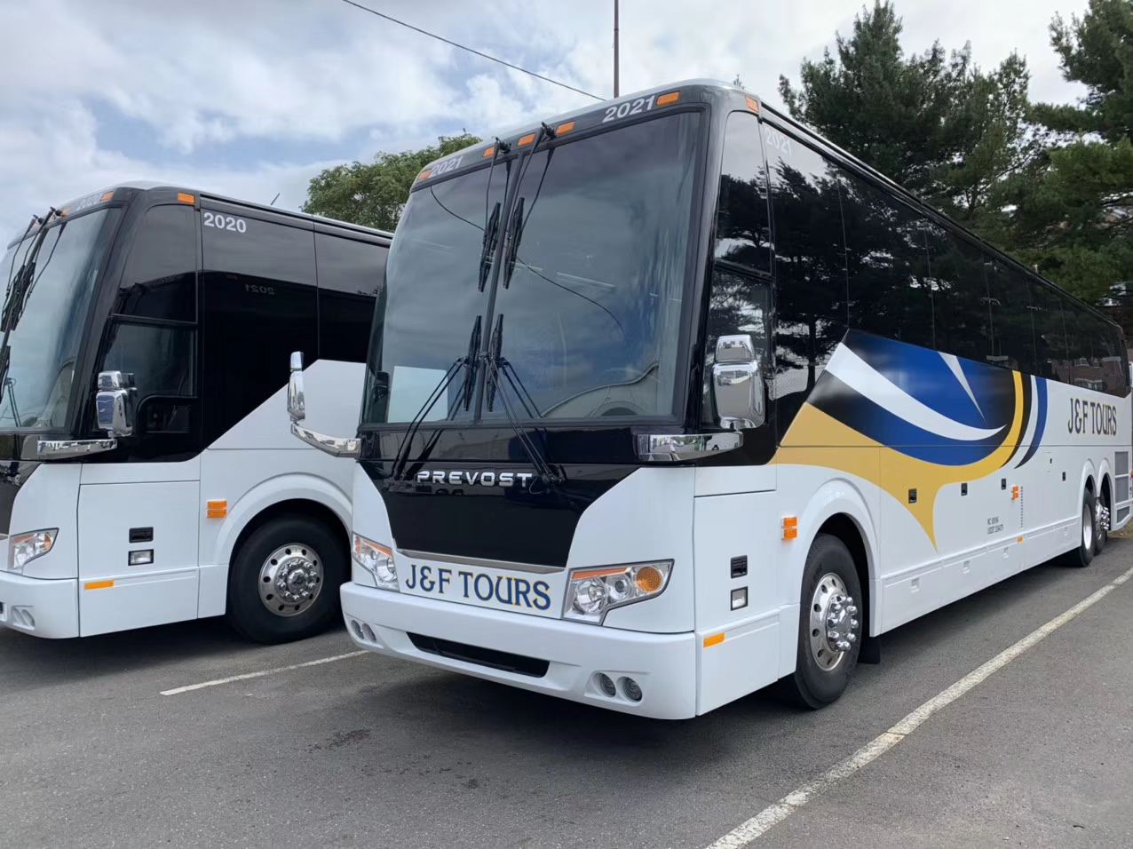 Two J&F Tours Prevost coaches parked side by side