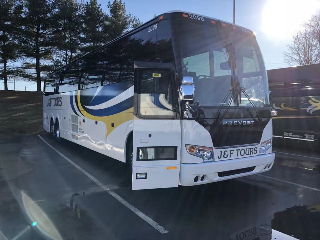 J&F Tours Prevost coach parked, side view